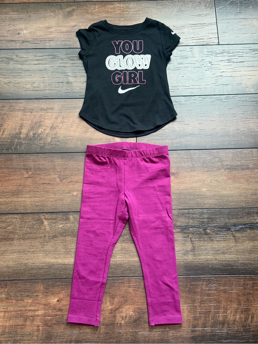 Nike two-piece set. Black tee with "YOU GLOW GIRL" graphic with matching legging